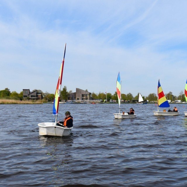 Youth sailing in an Optimist
