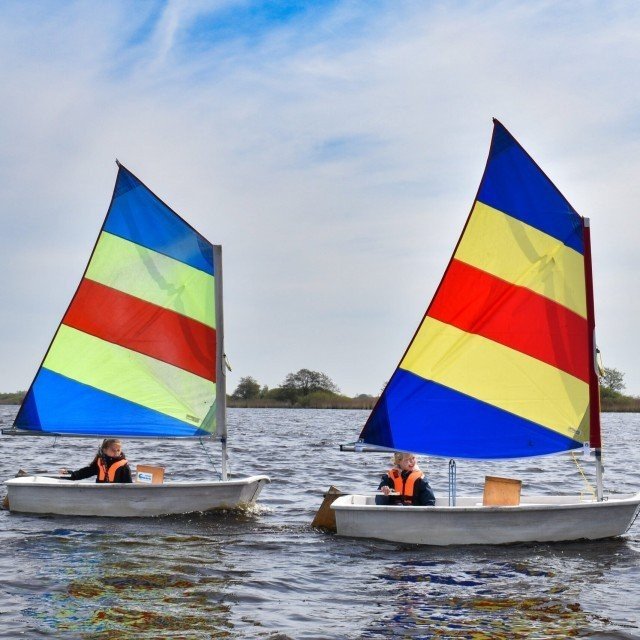 Youth sailing in an Optimist
